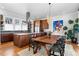 Open kitchen and dining area with stainless steel appliances, wooden cabinets, and modern fixtures at 1181 Cleburne Ne Ave, Atlanta, GA 30307