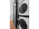 Contemporary laundry area with stacked washer/dryer and built in storage at 1181 Cleburne Ne Ave, Atlanta, GA 30307