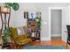 Comfortable sitting area featuring a wingback chair, a full bookshelf, and vibrant greenery at 1181 Cleburne Ne Ave, Atlanta, GA 30307