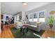 Spacious living room featuring a comfortable gray sectional sofa, bright windows, and stylish decor at 1181 Cleburne Ne Ave, Atlanta, GA 30307
