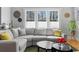 Cozy living room featuring a comfortable gray sectional sofa, bright windows, and stylish decor at 1181 Cleburne Ne Ave, Atlanta, GA 30307