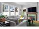 Bright living room featuring a fireplace, comfortable gray sofa, and ample natural light at 1181 Cleburne Ne Ave, Atlanta, GA 30307
