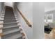 Carpeted staircase with wooden banister and view of the living room at 1181 Cleburne Ne Ave, Atlanta, GA 30307
