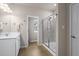 Modern bathroom featuring a glass-enclosed shower, single sink vanity, and tile flooring at 138 Bryon Ln, Acworth, GA 30102