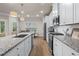 Bright kitchen boasts modern design, granite countertops, stainless steel appliances, and ample counter space at 138 Bryon Ln, Acworth, GA 30102