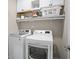 Functional laundry room equipped with modern washer, dryer, storage cabinets and shelving at 138 Bryon Ln, Acworth, GA 30102