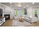 Cozy living room with a fireplace, plush seating, and natural light streaming through the windows at 138 Bryon Ln, Acworth, GA 30102