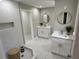 Elegant bathroom featuring double vanity sinks, modern lighting, and a marble shower with a built-in niche at 1387 Renee Dr, Decatur, GA 30035