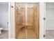 Bathroom featuring a glass enclosed shower, a tiled shower seat, and access to a walk-in closet at 255 Helens Manor Dr, Lawrenceville, GA 30045
