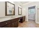 Bathroom featuring double sinks, dark wood cabinetry, a chandelier, and tile flooring at 255 Helens Manor Dr, Lawrenceville, GA 30045