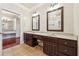 Bathroom featuring double sinks, dark wood cabinetry, a chandelier, and tile flooring at 255 Helens Manor Dr, Lawrenceville, GA 30045