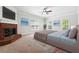 Spacious bedroom features a brick fireplace, ceiling fan, and natural light from the multiple windows at 255 Helens Manor Dr, Lawrenceville, GA 30045