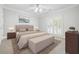 Bright bedroom with shuttered windows, ceiling fan, king bed, neutral walls, and a decorative area rug at 255 Helens Manor Dr, Lawrenceville, GA 30045