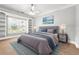 Bright bedroom with a bed, side tables, and a large window offering views and natural light at 255 Helens Manor Dr, Lawrenceville, GA 30045