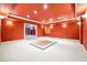 This bonus room features a striking red ceiling, carpet, and designer lighting at 255 Helens Manor Dr, Lawrenceville, GA 30045