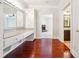 Dressing area with a long vanity, storage, gleaming hardwood floors, and access to additional spaces at 255 Helens Manor Dr, Lawrenceville, GA 30045