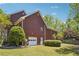 Charming two-story brick home with lush greenery, a well-manicured lawn and attached garage at 255 Helens Manor Dr, Lawrenceville, GA 30045