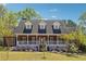 Beautiful brick home with a welcoming front porch and colorful flower beds at 255 Helens Manor Dr, Lawrenceville, GA 30045