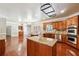 A gourmet kitchen features a center island, wooden cabinets, and stainless steel appliances at 255 Helens Manor Dr, Lawrenceville, GA 30045