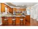 Traditional kitchen featuring wood cabinets, granite countertops, stainless steel appliances and hardwood floors at 255 Helens Manor Dr, Lawrenceville, GA 30045