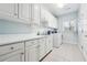Bright laundry room featuring modern appliances, tiled floor, and plenty of storage at 255 Helens Manor Dr, Lawrenceville, GA 30045