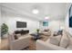 Stylish living room with modern furniture, large TV, and decorative lighting for comfortable living at 255 Helens Manor Dr, Lawrenceville, GA 30045