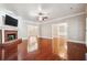 Bright living room boasts hardwood floors, brick fireplace, and an open layout with ample natural light at 255 Helens Manor Dr, Lawrenceville, GA 30045