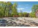 Covered pool surrounded by a brick patio and mature trees at 255 Helens Manor Dr, Lawrenceville, GA 30045
