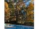 Inviting in-ground pool surrounded by a patio and fall foliage offering a relaxing backyard retreat at 255 Helens Manor Dr, Lawrenceville, GA 30045