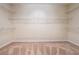 Empty walk-in closet featuring carpet and white shelving at 255 Helens Manor Dr, Lawrenceville, GA 30045
