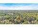 Aerial view showcasing a serene, treed neighborhood and home's convenient location at 30 Sweetwood Ct, Roswell, GA 30076
