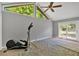 Large bonus room with vaulted ceiling, ample natural light, and access to outdoor patio at 30 Sweetwood Ct, Roswell, GA 30076
