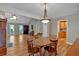 Open-concept dining area with hardwood floors, modern lighting, and views into the living room at 30 Sweetwood Ct, Roswell, GA 30076