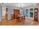 Cozy dining room featuring wood floors, a chandelier, and views of the landscaped backyard at 30 Sweetwood Ct, Roswell, GA 30076