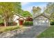 Charming single-story home with a well-manicured lawn, driveway, and attached garage at 30 Sweetwood Ct, Roswell, GA 30076
