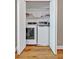 A laundry closet featuring a washer and dryer, with shelving and storage space, conveniently tucked away at 30 Sweetwood Ct, Roswell, GA 30076
