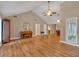 Open-concept living area with vaulted ceilings, wood floors, and ample natural light at 30 Sweetwood Ct, Roswell, GA 30076