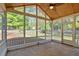 A screened porch with stone flooring and a fan looking out to the fenced backyard at 30 Sweetwood Ct, Roswell, GA 30076