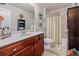 Bathroom with wood vanity, shower-tub combination, and decorative accents at 4015 Two Bridge Ct, Buford, GA 30518