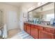 Elegant primary bathroom featuring double sinks, granite countertops, and a large mirror at 4015 Two Bridge Ct, Buford, GA 30518