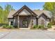 Charming community clubhouse featuring stone accents, double-door entry, and professionally landscaped surroundings at 4015 Two Bridge Ct, Buford, GA 30518