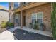 Charming front porch with decorative plants and stylish planters leading to the front door at 4015 Two Bridge Ct, Buford, GA 30518