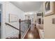 Upstairs hallway featuring hardwood floors, wainscotting, and leads to other areas of the home at 4015 Two Bridge Ct, Buford, GA 30518