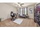 Bright home office with a desk, love seat, decorative artwork, and carpet flooring at 4015 Two Bridge Ct, Buford, GA 30518