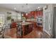 Open kitchen featuring stainless steel appliances, a breakfast bar, and dark wood cabinets at 4015 Two Bridge Ct, Buford, GA 30518