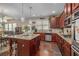Open kitchen with granite island, stainless appliances, and seamlessly connects to the dining and living areas at 4015 Two Bridge Ct, Buford, GA 30518