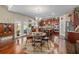 Open kitchen with dark cabinets, a breakfast table, and hardwood floors at 4015 Two Bridge Ct, Buford, GA 30518