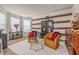 Cozy living room with striped accent wall, decorative furnishings, and natural light at 4015 Two Bridge Ct, Buford, GA 30518