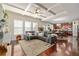 Open-concept living room with coffered ceilings, hardwood floors, and a comfortable seating area at 4015 Two Bridge Ct, Buford, GA 30518