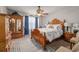 Comfortable bedroom with wooden furniture, ceiling fan, patterned bedding, and carpet flooring at 4015 Two Bridge Ct, Buford, GA 30518
